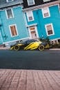 Colorful car on asphalt road near pavement