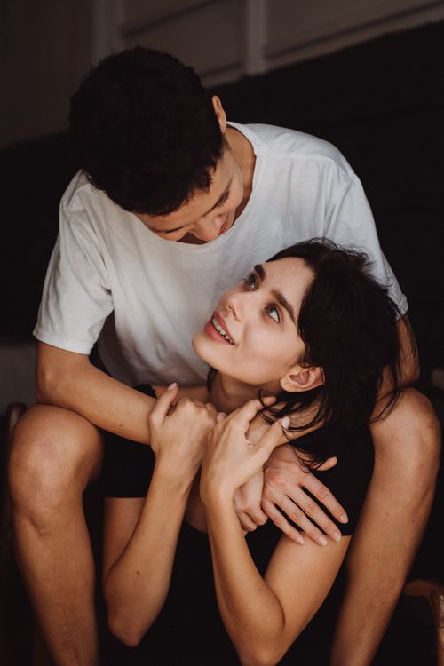 Free An affectionate couple embraces with joyful expressions, showcasing a warm and intimate moment. Stock Photo