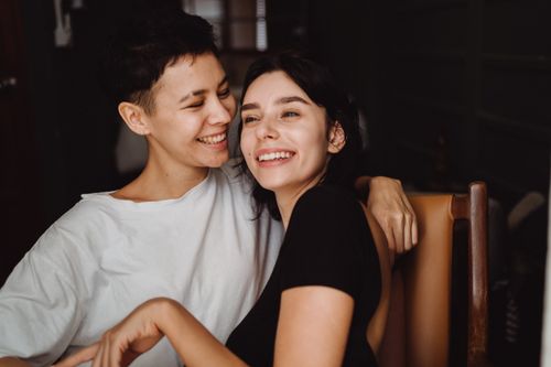 Free A joyful couple sharing a warm embrace and smile indoors, capturing a moment of happiness and connection. Stock Photo