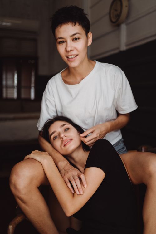 Free A cheerful, affectionate couple relaxing together indoors, highlighting love and connection. Stock Photo