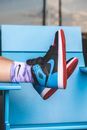 Person Wearing Black and Red Nike Air Jordan 1 Shoes