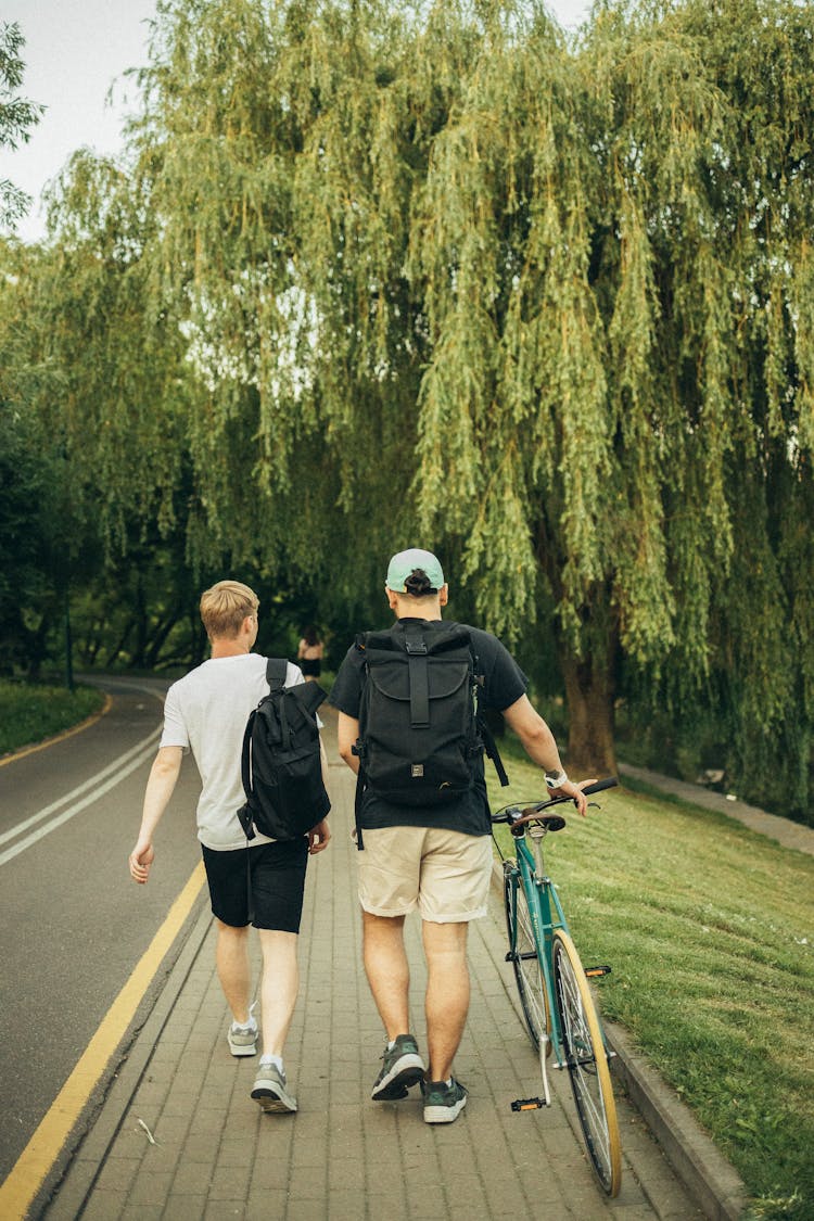 Men Walking On Sidewalk