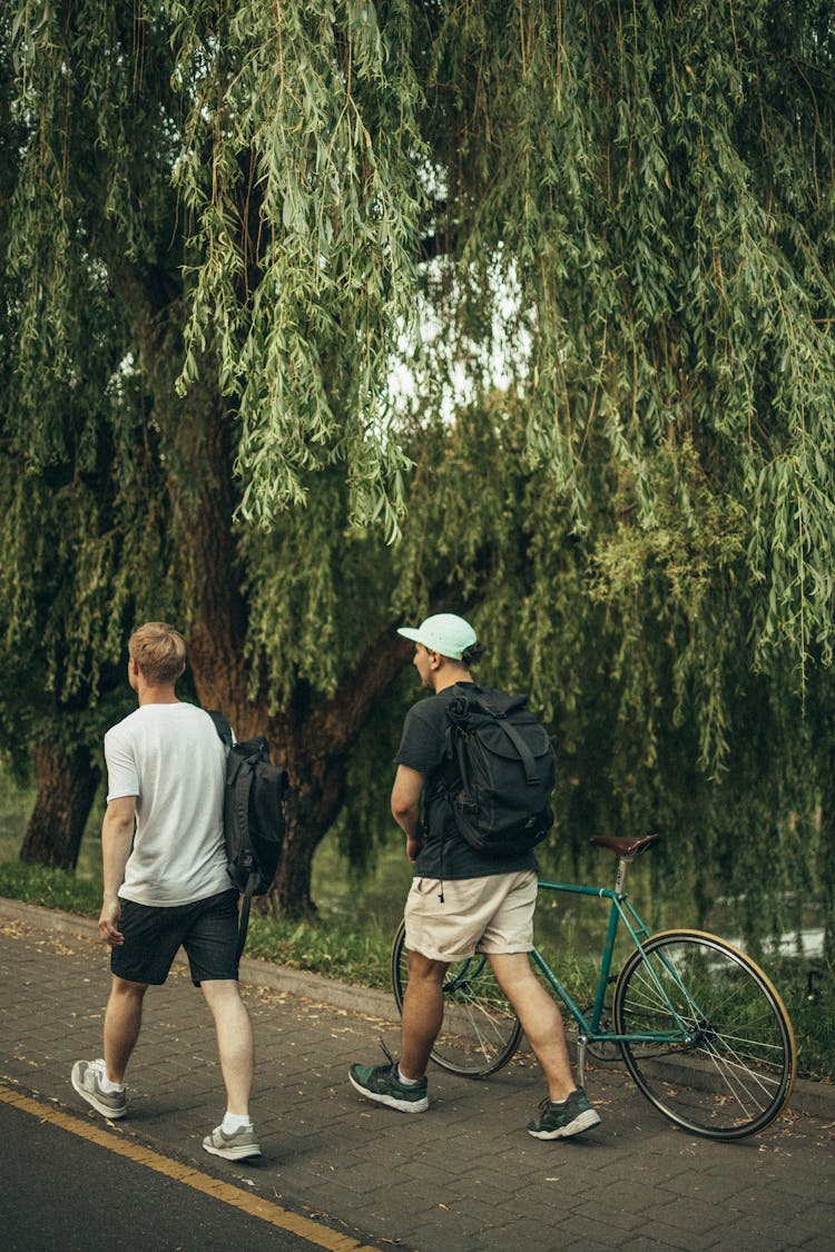 Photo Of Men Walking Together On Sidewalk