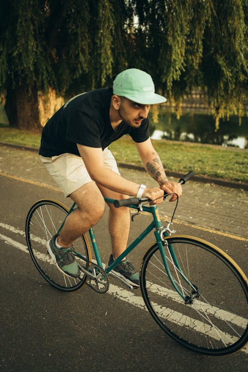 Man in Black T-shirt on a Bicycle