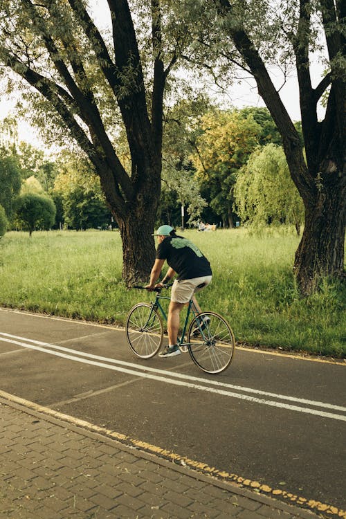 Man in Black T-shirt Riding a Bicycle