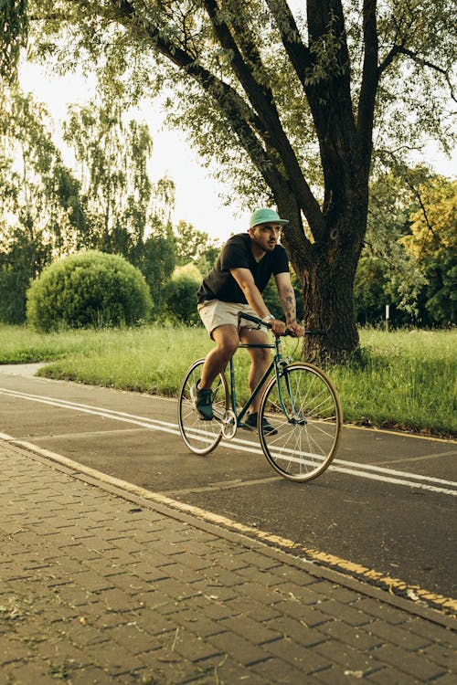 Man in Black T-shirt Riding on Bicycle 