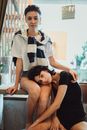 Portrait of Two Brunettes Sitting in an Interior