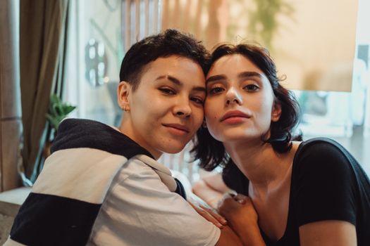 Close-up image of a smiling couple indoors, showcasing affection and happiness.