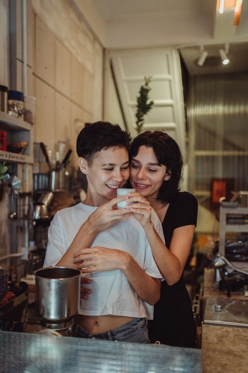Free A loving couple shares a moment with coffee in a cozy, modern kitchen setting. Stock Photo