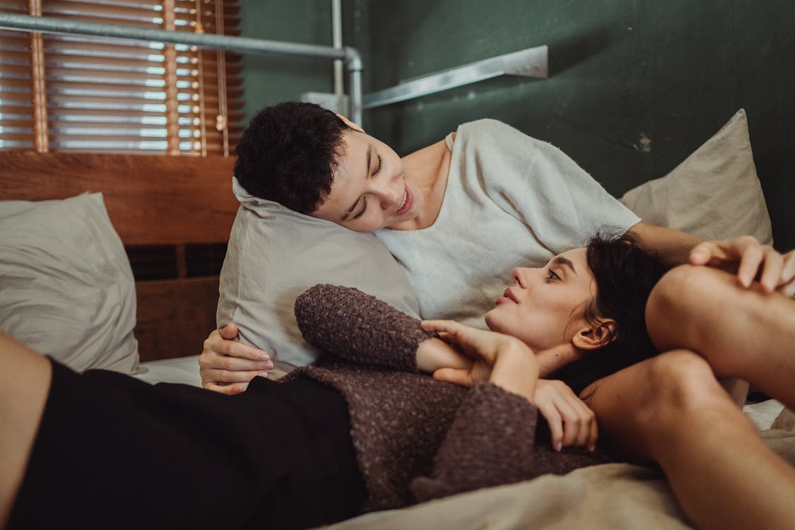 Free Couple Talking in Bed Stock Photo
