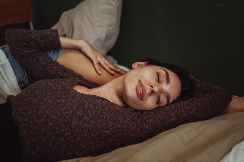 Free Close-up of two women lying down with eyes closed, showcasing intimacy and relaxation indoors. Stock Photo