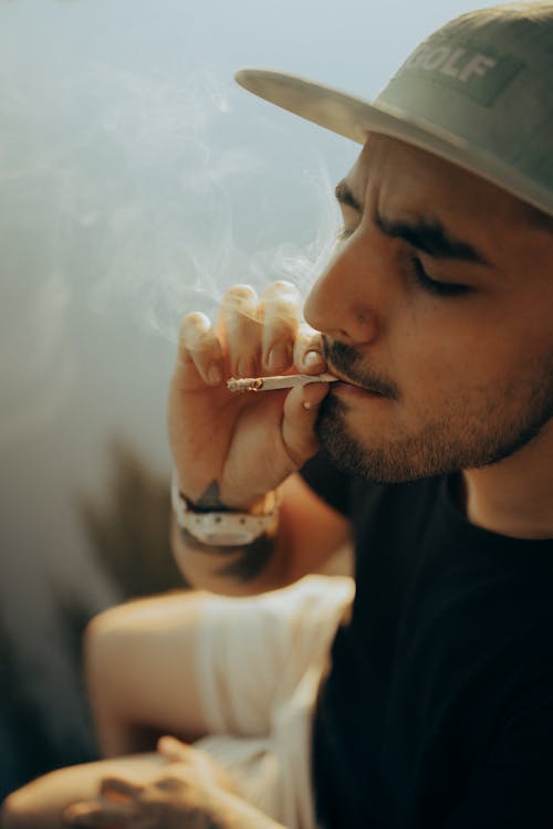 A Bearded Man Smoking a Cigarette