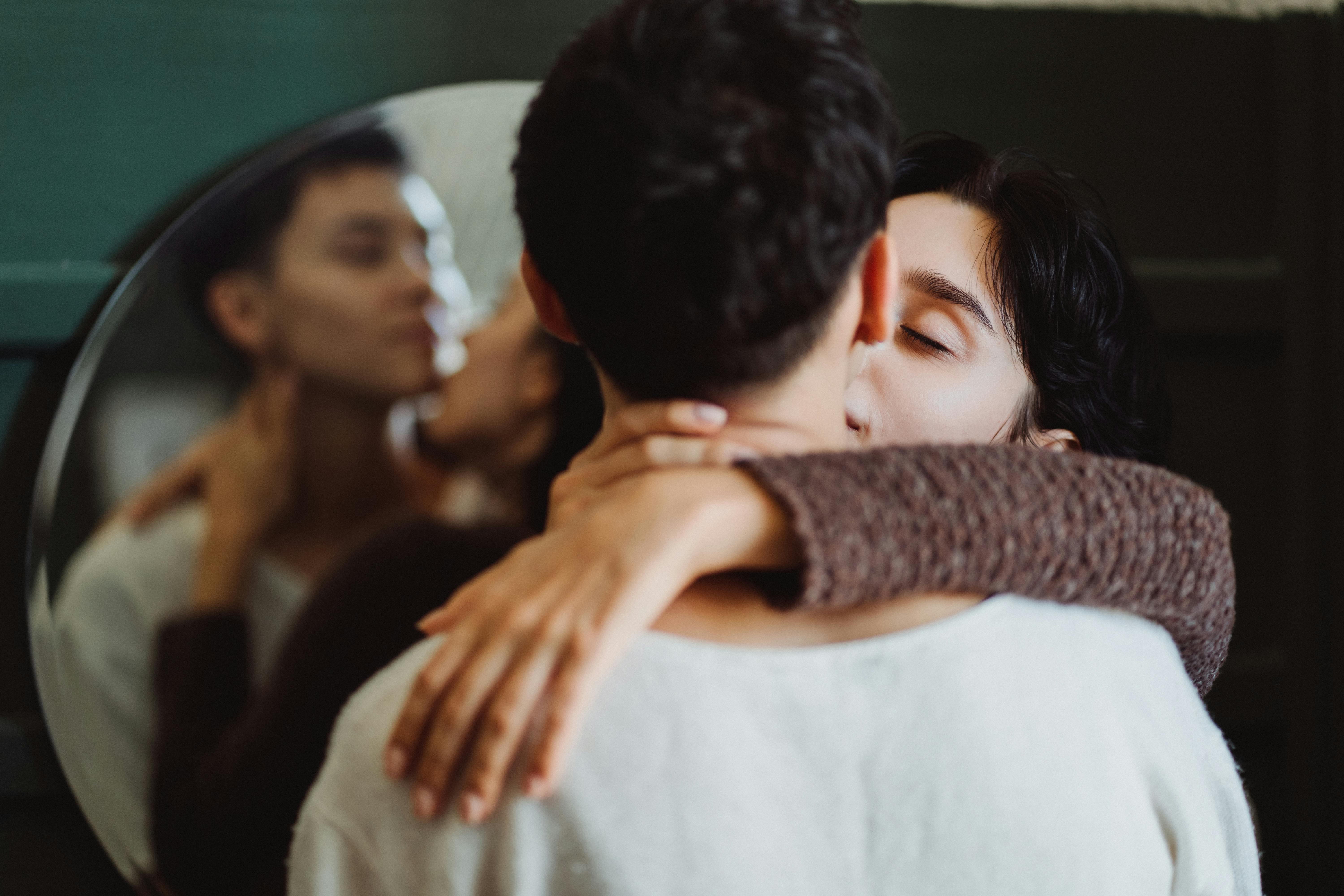 Black gay couple kissing and hugging in illuminating city street · Free Stock Photo