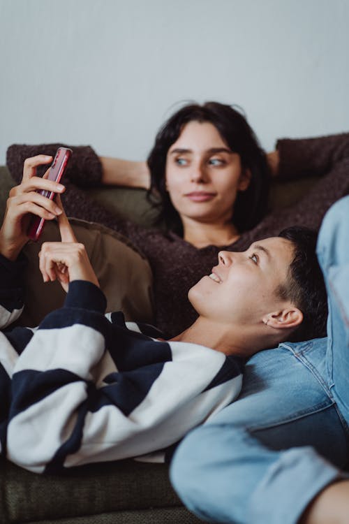 Free Couple Lying Down on Couch Stock Photo