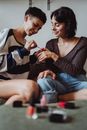 Women Painting each others Nails
