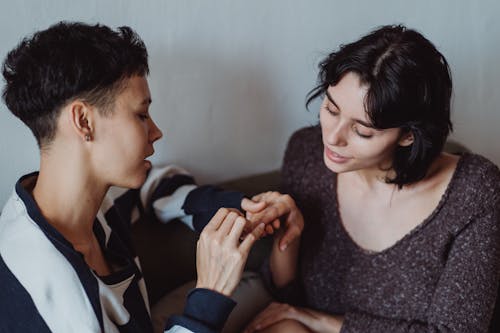 Free Woman Receiving Manicure from Partner Stock Photo