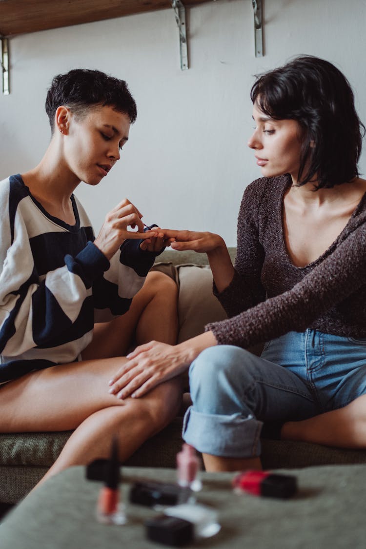 Woman Painting Her Girlfriends Nails 