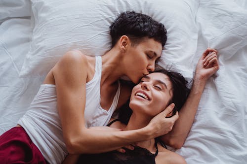 Free Woman Kissing Another Woman on the Forehead Stock Photo