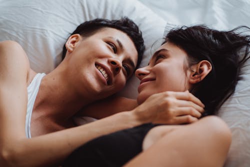 Free Two Women in Bed Looking at Each Other Stock Photo