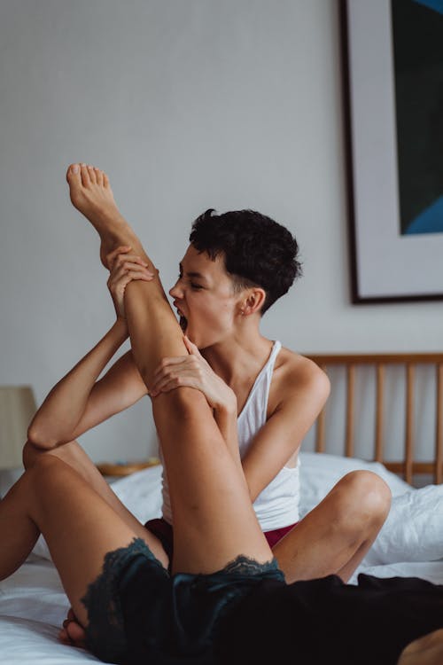 Free Woman Holding Another Woman's Leg Stock Photo