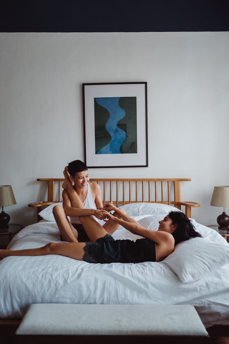 Couple Play Fighting In Bed 