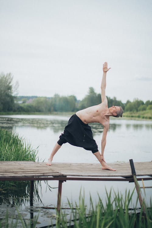 Man Doing Yoga on a Pier