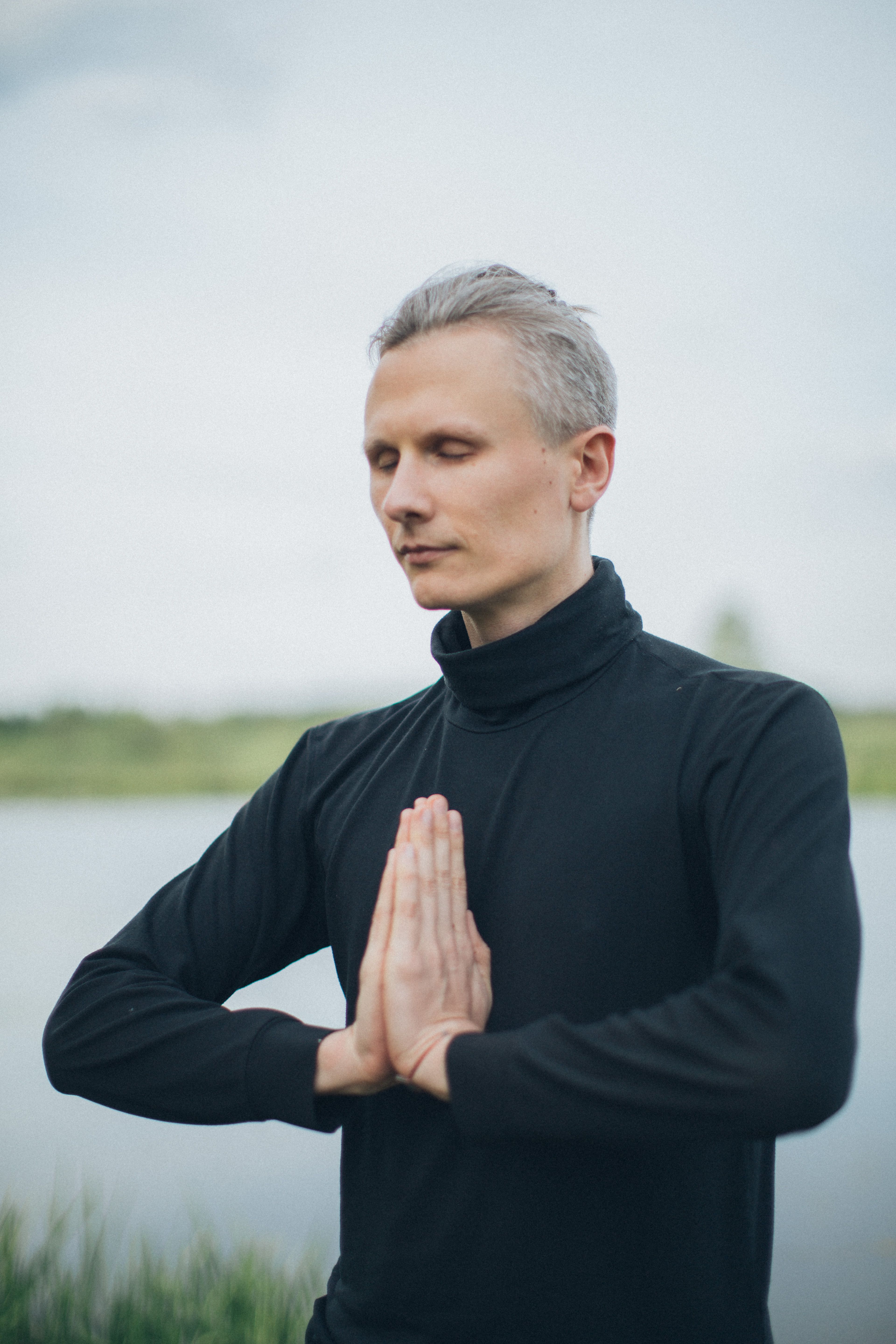 Man outdoors with eyes closed in a calm meditation posture