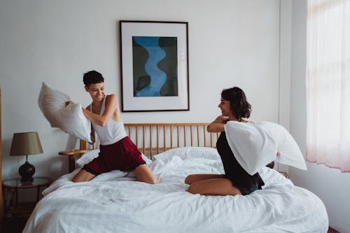 Free Two Women Having a Pillow Fight Stock Photo