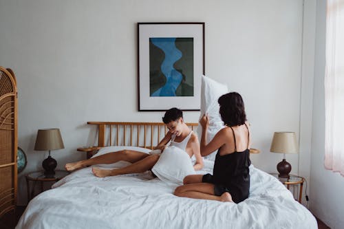 Free Two Women Having a Pillow Fight Stock Photo