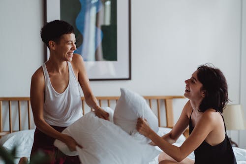 Free Two Women Having a Pillow Fight Stock Photo