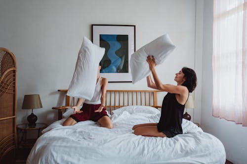 Two Women Playing With Pillows