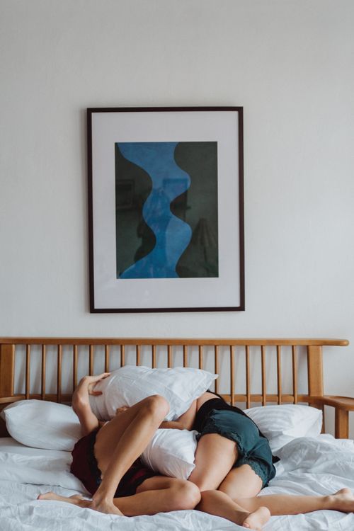 Free Intimate moment of a couple relaxing and enjoying each other's company in bed. Stock Photo