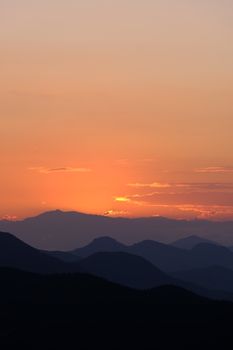 Captivating sunset over Artvin's mountains with an orange sky. Perfect for nature lovers seeking tranquility.