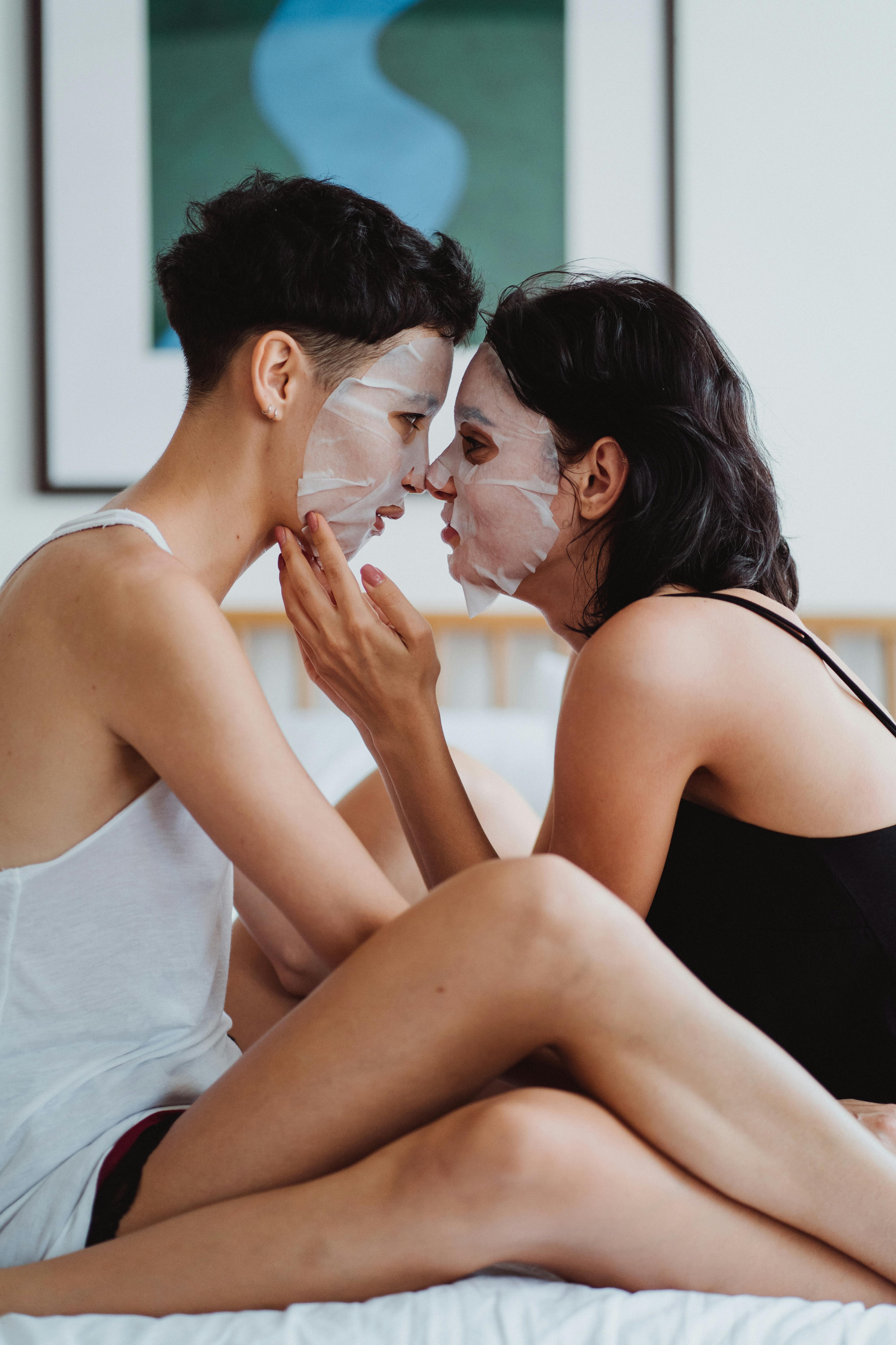 a couple with sheet masks on their face