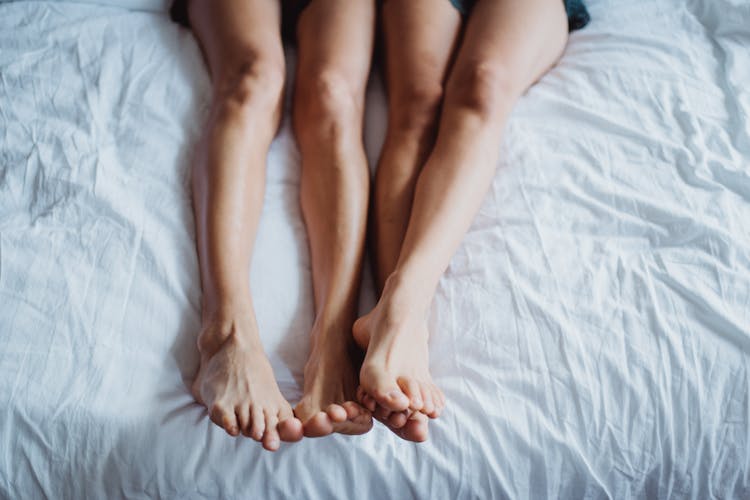 Couple Legs In Bed