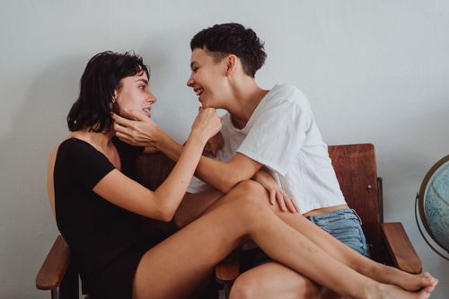 Free Two women sharing a joyful and affectionate moment indoors, expressing love and intimacy. Stock Photo