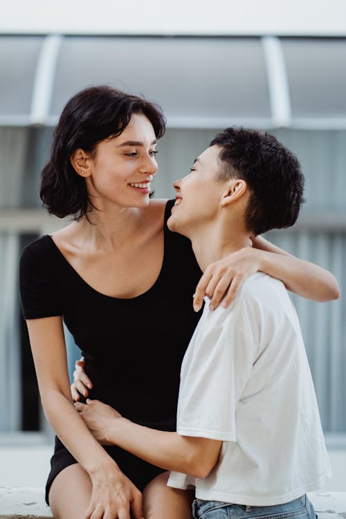 Free A Couple Smiling and Looking at each other Stock Photo