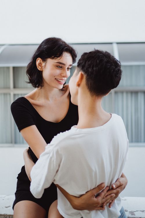 Free A loving couple embracing and sharing a joyful moment indoors. Stock Photo