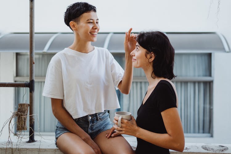 Couple Sitting On Balcony Talking