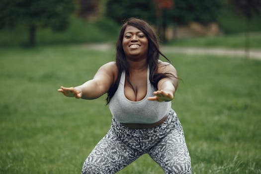 Smiling woman practicing yoga outdoors, embracing wellness and a healthy lifestyle.