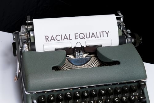Free Close-up of a vintage typewriter with a paper stating 'Racial Equality'. Stock Photo