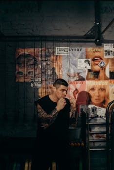 Male athlete in an urban gym engaging in shadowboxing practice with bold posters in the background.