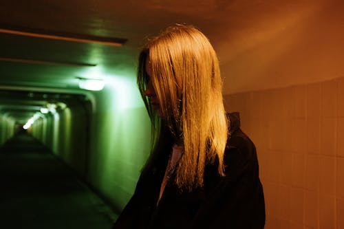 Woman in Black Coat Standing in Front of Mirror