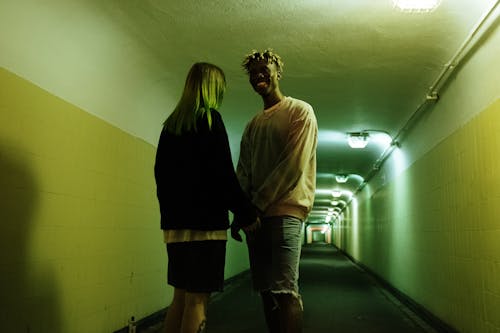 Man and Woman Walking on Hallway