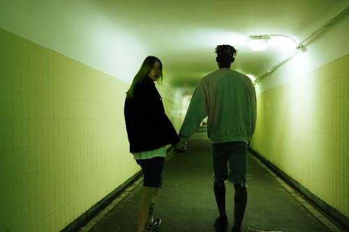 Man and Woman Walking on Hallway