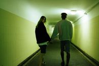 Man and Woman Walking on Hallway