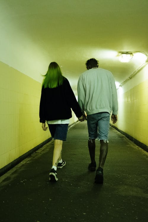 Free Man and Woman Walking on Hallway Stock Photo