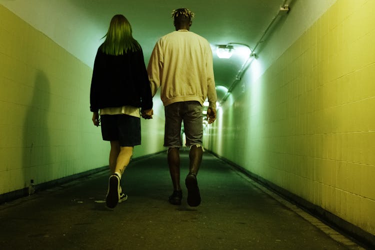 Man And Woman Walking On Hallway