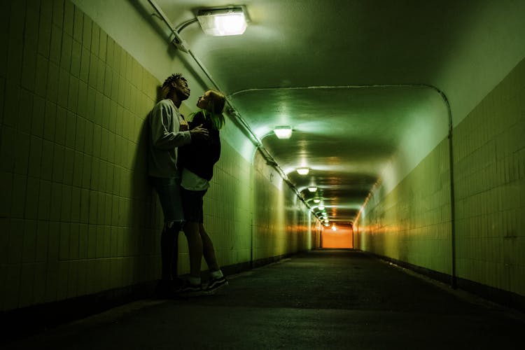 Man In Gray Jacket Walking On Hallway