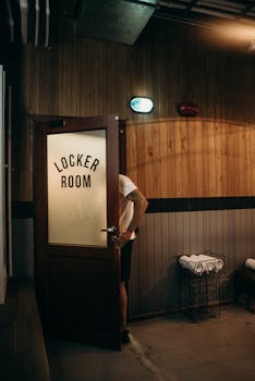 A person entering a wooden locker room creating an intriguing and anonymous scene.
